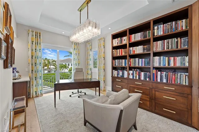 a living room with fireplace furniture and a book shelf