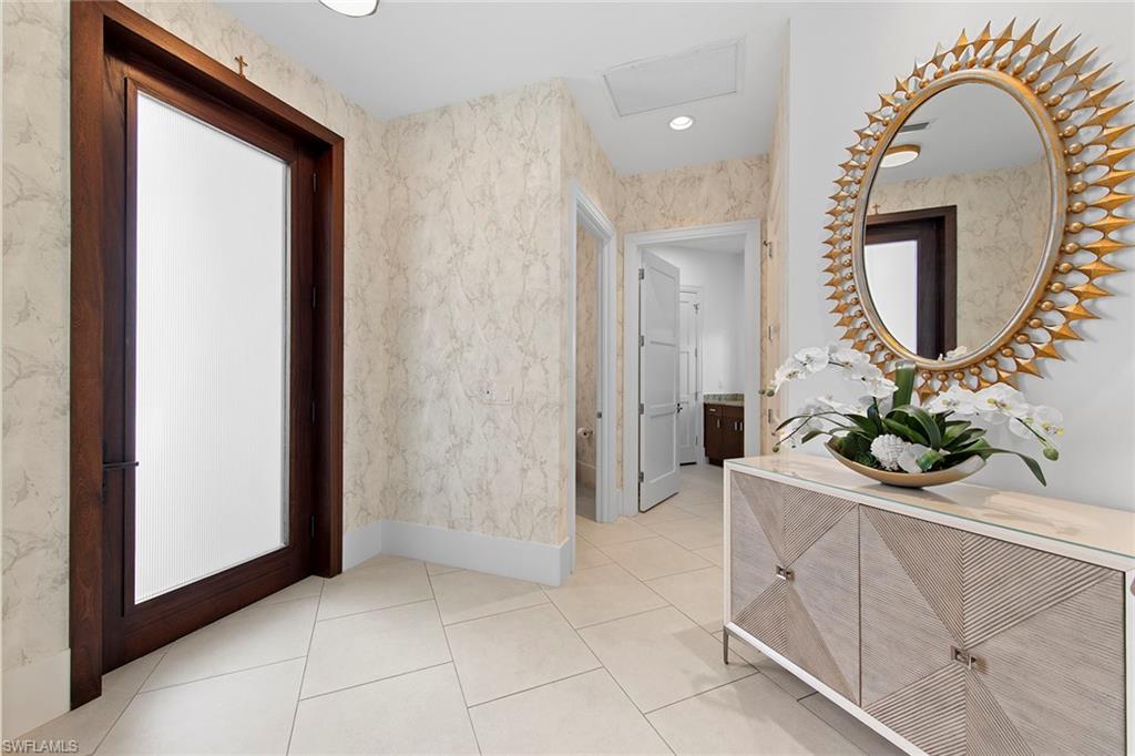 9149 Mercato Way Naples, FL 34108 - Photo 3 of 39 a room with mirror and entrance