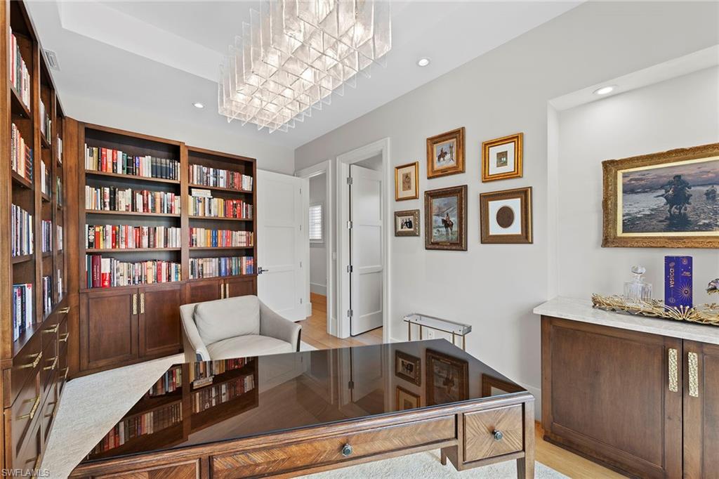 9149 Mercato Way Naples, FL 34108 - Photo 31 of 39 a living room with furniture and a bookshelf
