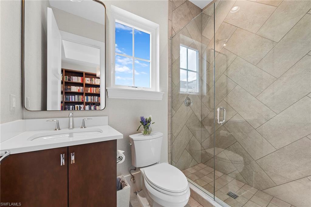 9149 Mercato Way Naples, FL 34108 - Photo 32 of 39 a bathroom with a sink a toilet and shower