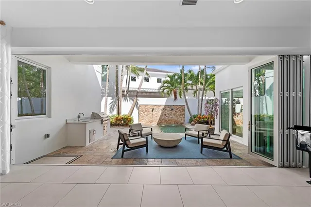 a living room with furniture and a potted plant