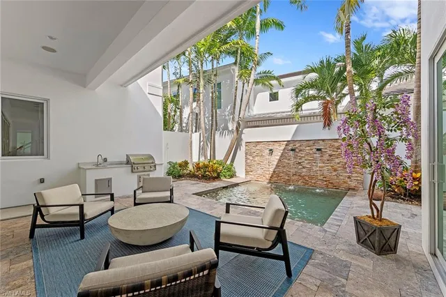 a living room with furniture and a potted plant