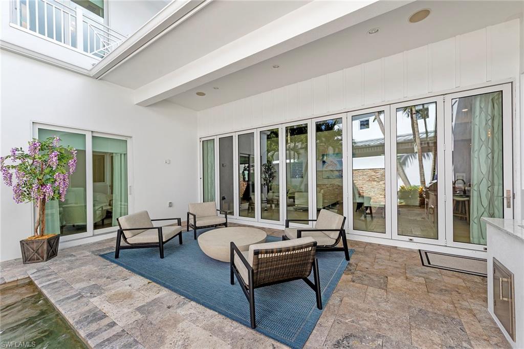 9149 Mercato Way Naples, FL 34108 - Photo 36 of 39 a living room with furniture and a potted plant