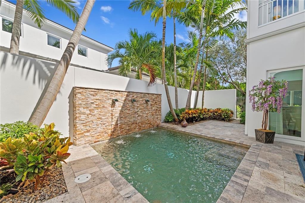 9149 Mercato Way Naples, FL 34108 - Photo 37 of 39 a view of a street with potted plants
