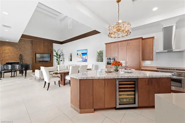 a kitchen with a dining table chairs and a refrigerator