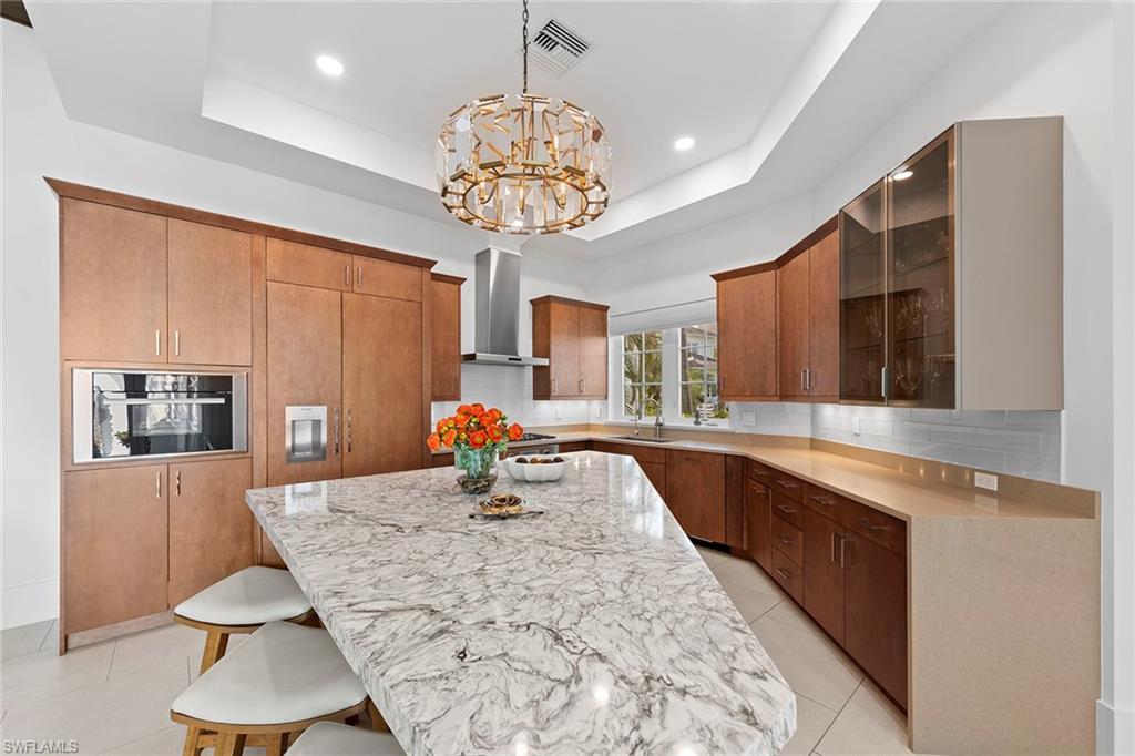 9149 Mercato Way Naples, FL 34108 - Photo 7 of 39 a kitchen with a table chairs and microwave