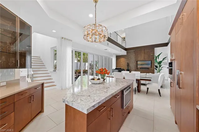 a very nice looking kitchen with granite countertop a large island in the center