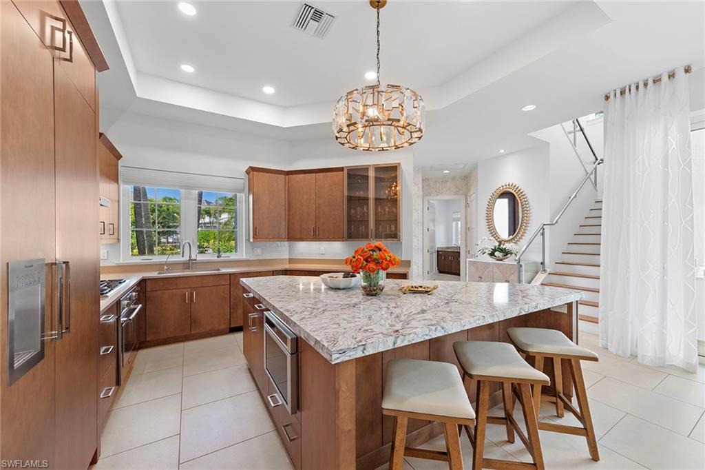9149 Mercato Way Naples, FL 34108 - Photo 8 of 39 a kitchen with a counter space a sink and appliances