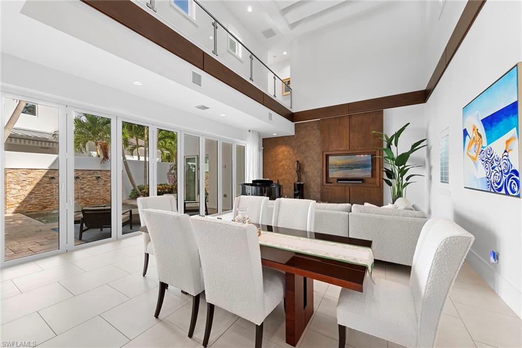 9149 Mercato Way Naples, FL 34108 - Photo 8 of 39 a living room with furniture a rug and a large window