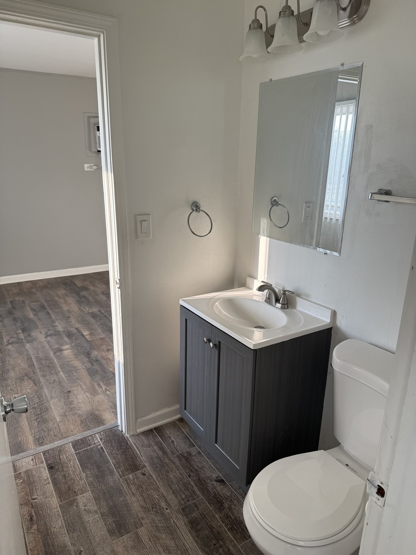 314 Lathrop Avenue, Unit 502 Forest Park, IL 60130 - Photo 7 of 9 a bathroom with a sink vanity mirror and toilet