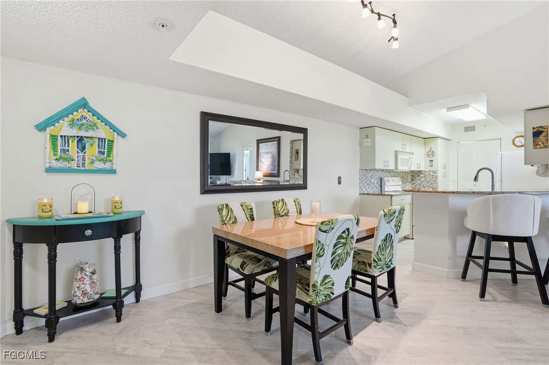 13581 Eagle Ridge Drive, Unit 1434 Fort Myers, FL 33912 - Photo 11 of 45 a view of a dining room with furniture