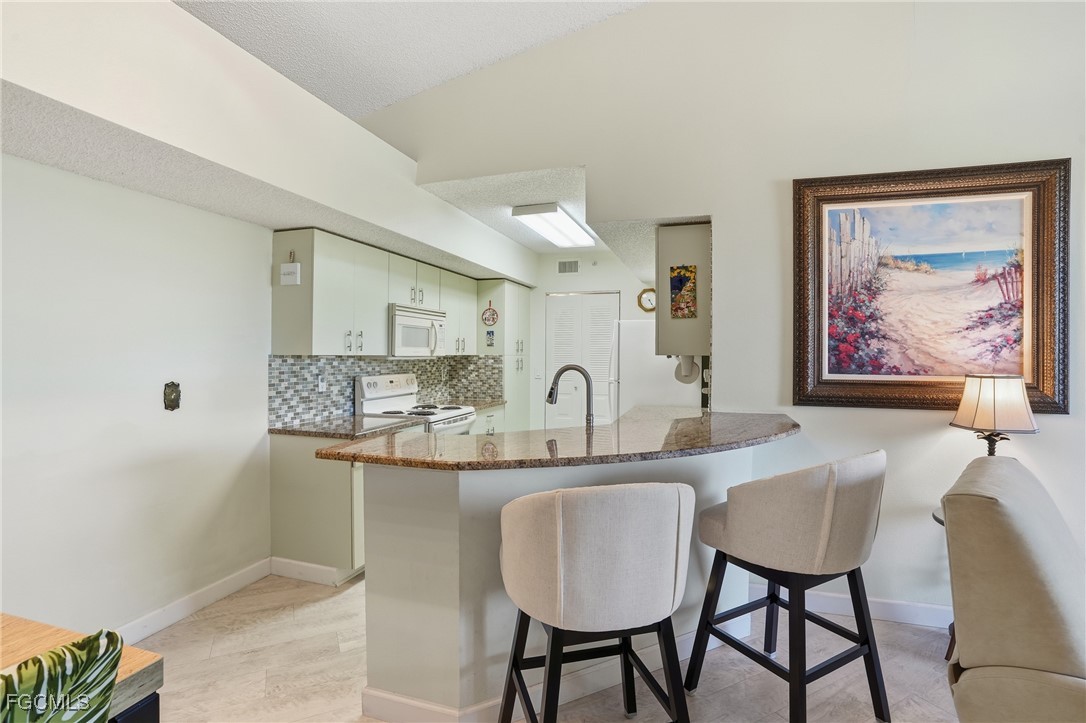 13581 Eagle Ridge Drive, Unit 1434 Fort Myers, FL 33912 - Photo 12 of 45 a dining room with furniture and window