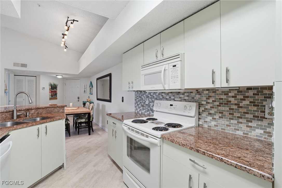 13581 Eagle Ridge Drive, Unit 1434 Fort Myers, FL 33912 - Photo 14 of 45 a kitchen with a stove and a sink