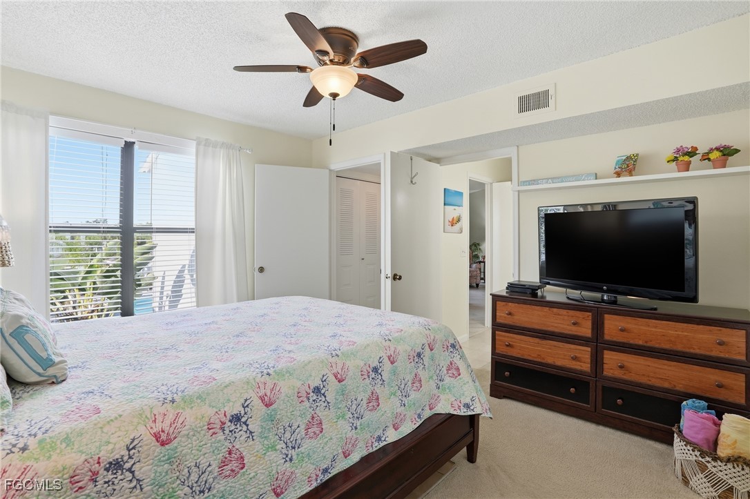 13581 Eagle Ridge Drive, Unit 1434 Fort Myers, FL 33912 - Photo 19 of 45 a bedroom with a bed and a flat screen tv