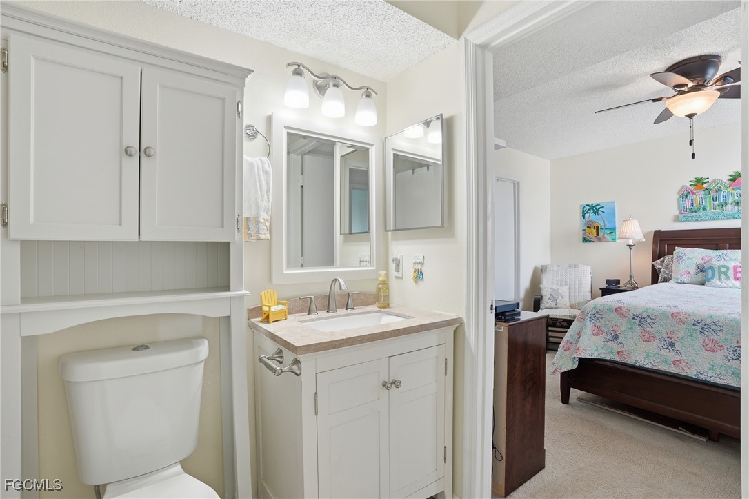 13581 Eagle Ridge Drive, Unit 1434 Fort Myers, FL 33912 - Photo 20 of 45 a bedroom with a bed and a table in it