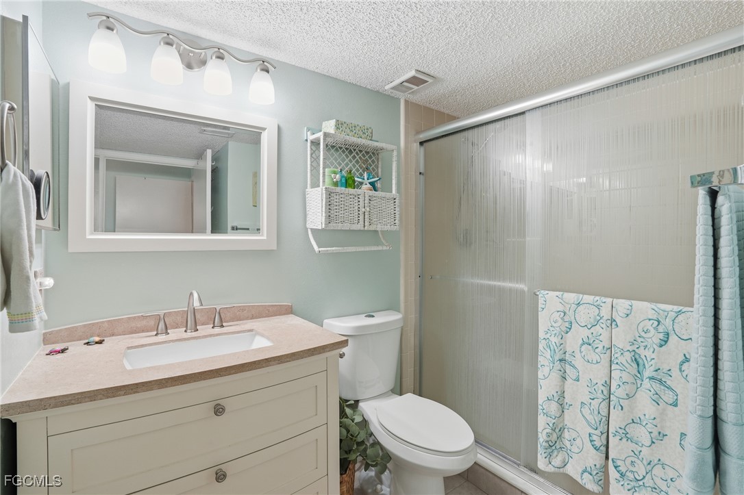 13581 Eagle Ridge Drive, Unit 1434 Fort Myers, FL 33912 - Photo 22 of 45 a bathroom with a sink toilet and shower