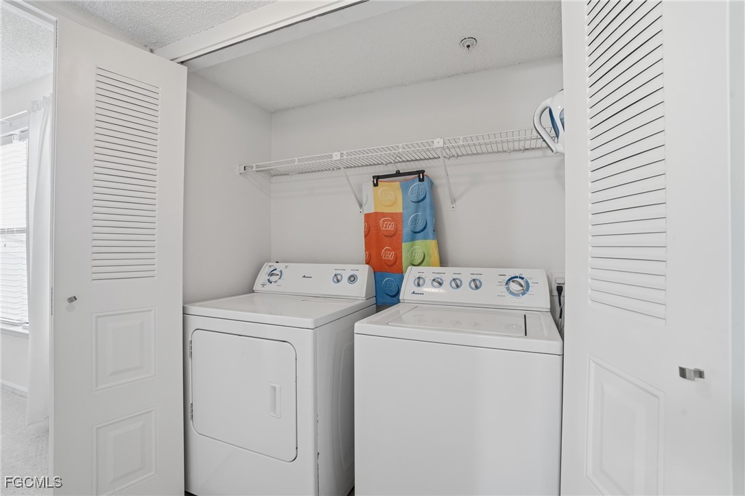 13581 Eagle Ridge Drive, Unit 1434 Fort Myers, FL 33912 - Photo 23 of 45 a view of storage and utility room with washer and dryer