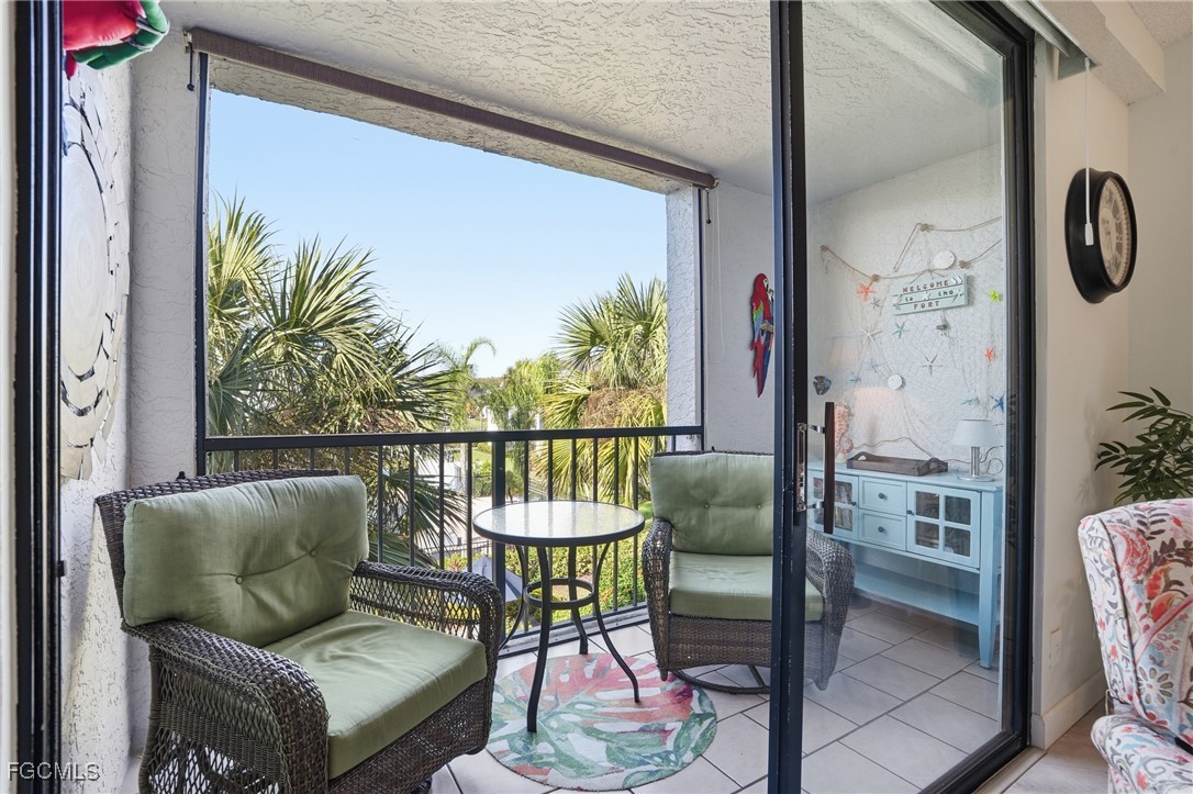 13581 Eagle Ridge Drive, Unit 1434 Fort Myers, FL 33912 - Photo 26 of 45 a balcony with table and chairs