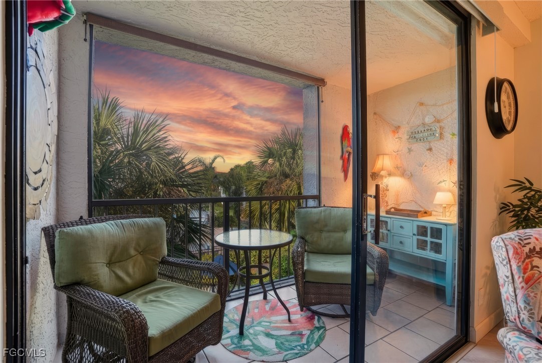 13581 Eagle Ridge Drive, Unit 1434 Fort Myers, FL 33912 - Photo 27 of 45 a balcony with table and chairs
