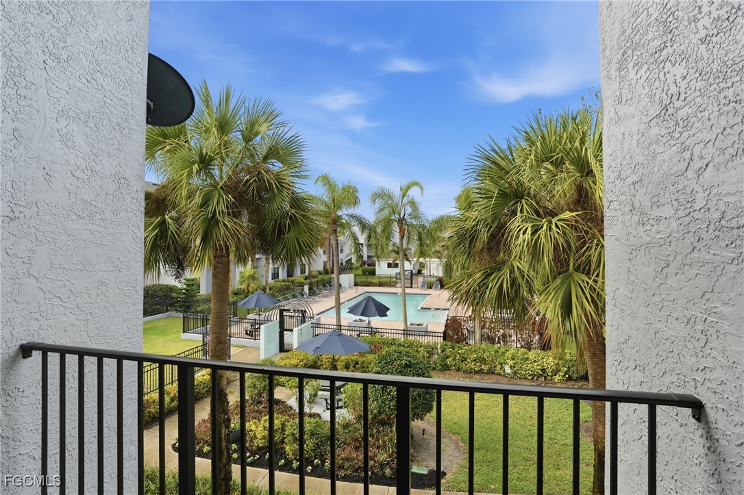 13581 Eagle Ridge Drive, Unit 1434 Fort Myers, FL 33912 - Photo 28 of 45 a view of a balcony with plants and palm trees