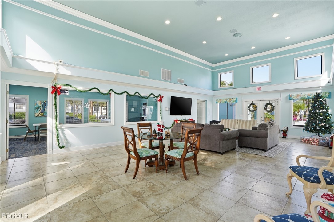 13581 Eagle Ridge Drive, Unit 1434 Fort Myers, FL 33912 - Photo 36 of 45 a living room with furniture and a flat screen tv