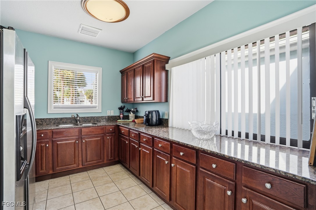 13581 Eagle Ridge Drive, Unit 1434 Fort Myers, FL 33912 - Photo 38 of 45 a kitchen with stainless steel appliances granite countertop a sink and a white cabinets