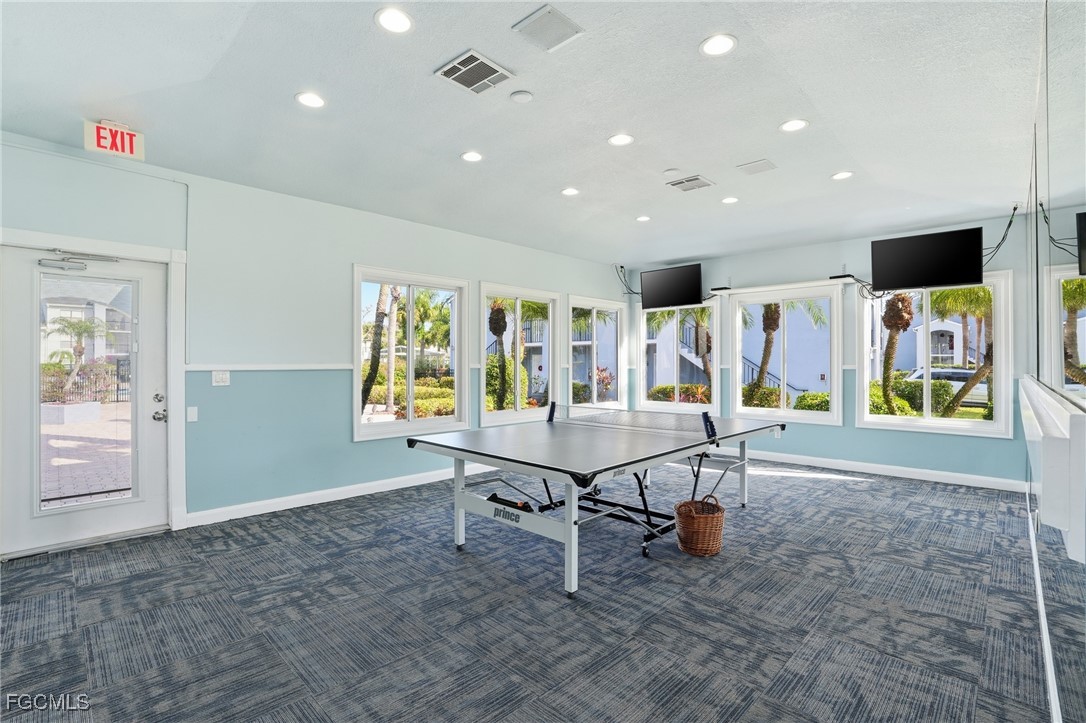 13581 Eagle Ridge Drive, Unit 1434 Fort Myers, FL 33912 - Photo 40 of 45 a room with table tennis air hockey table and chairs