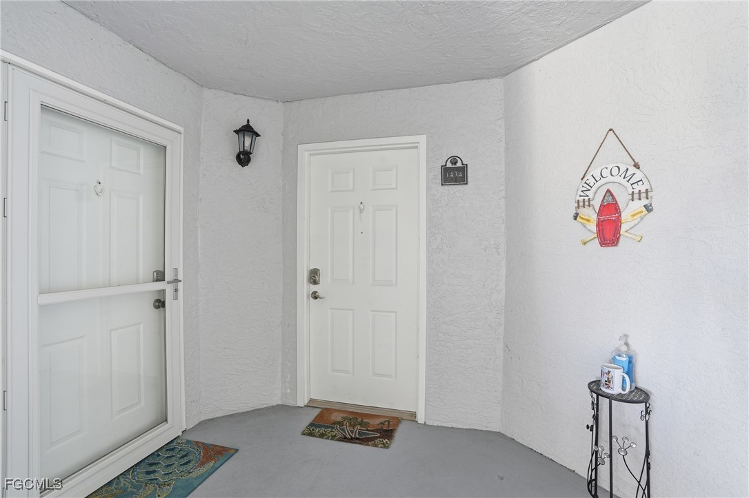 13581 Eagle Ridge Drive, Unit 1434 Fort Myers, FL 33912 - Photo 4 of 45 a view of an entryway with wooden floor