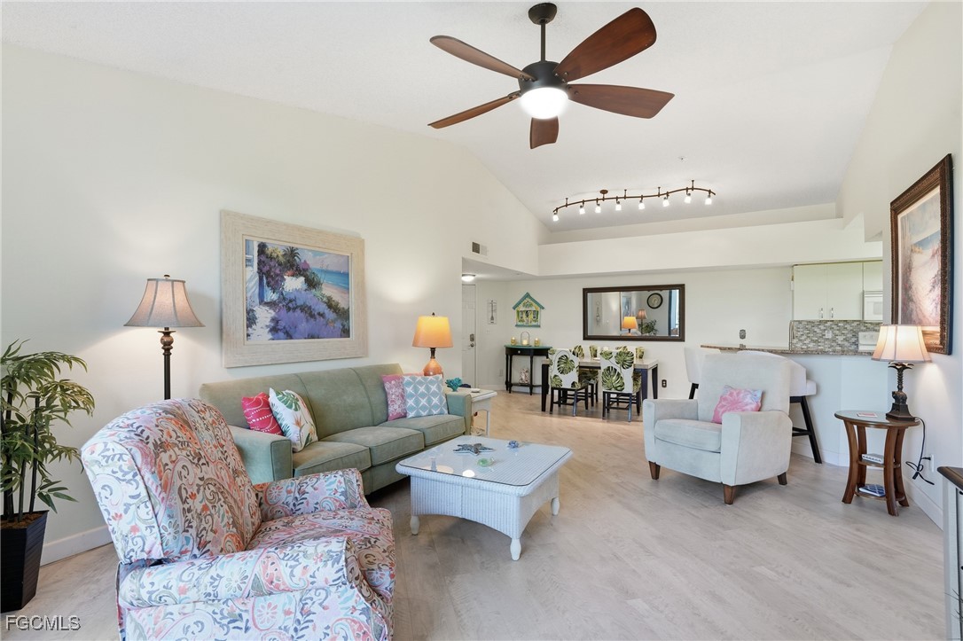 13581 Eagle Ridge Drive, Unit 1434 Fort Myers, FL 33912 - Photo 7 of 45 a living room with furniture and a chandelier
