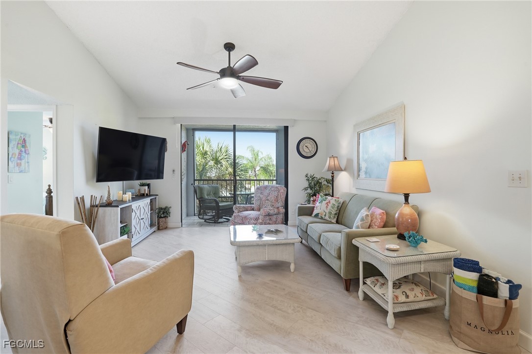 13581 Eagle Ridge Drive, Unit 1434 Fort Myers, FL 33912 - Photo 9 of 45 a living room with furniture and a flat screen tv