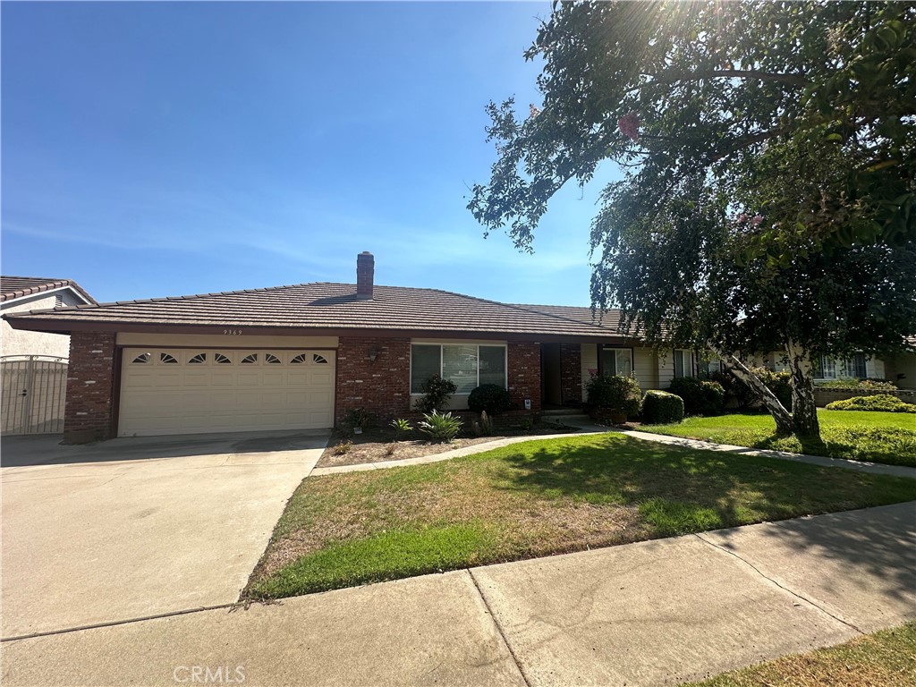 9369 Lemon Avenue Rancho Cucamonga, CA 91701 - Photo 1 of 1 a front view of a house with a yard
