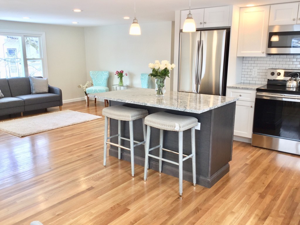 16 Alwin Street Boston, MA 02136 - Photo 1 of 19 a kitchen with stainless steel appliances kitchen island granite countertop a table chairs and a refrigerator