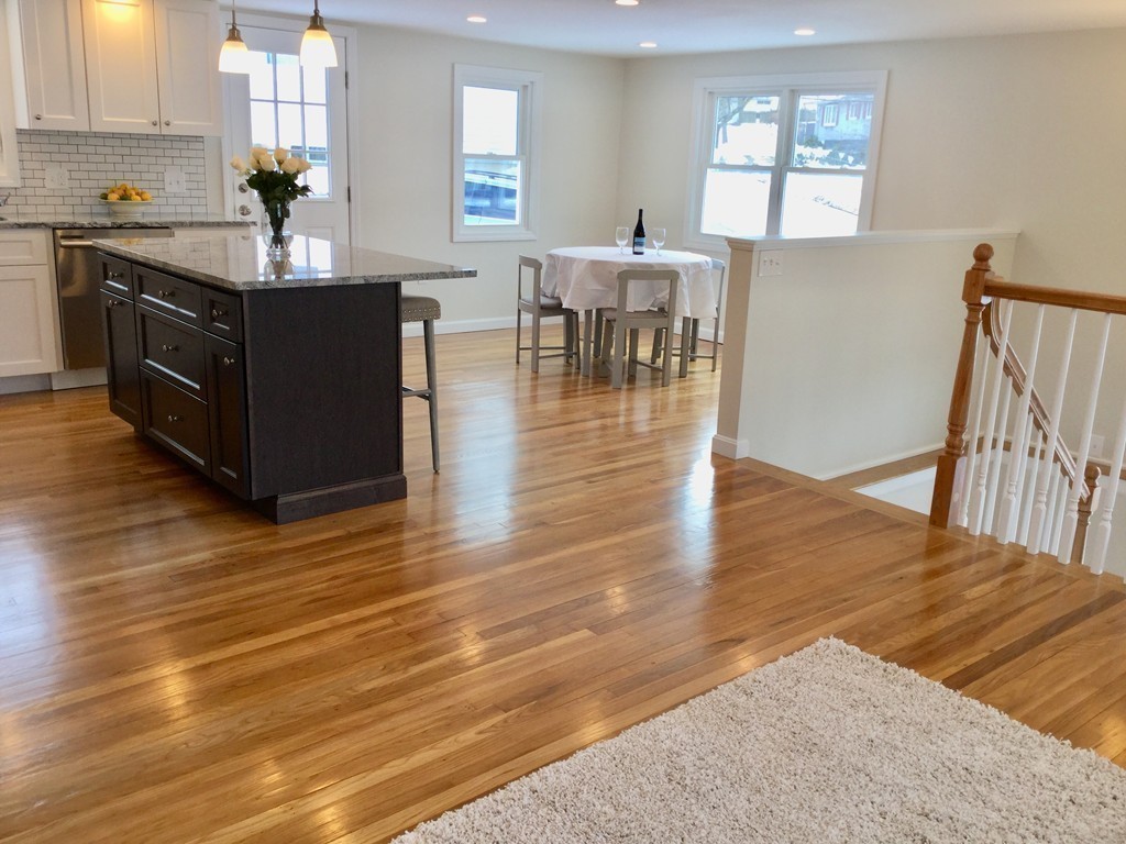 16 Alwin Street Boston, MA 02136 - Photo 8 of 19 a kitchen with stainless steel appliances granite countertop a sink dishwasher and a dining table with wooden floor
