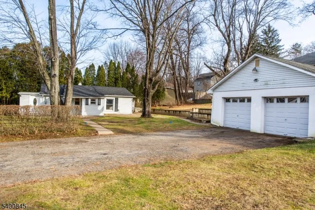 a view of a house with a yard covered in snow