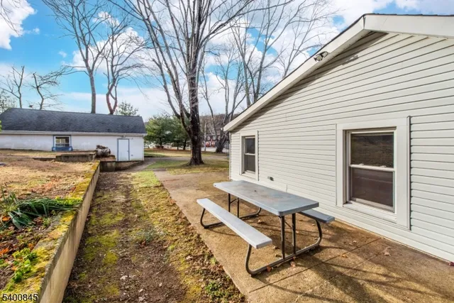 a view of a patio with table and chairs with wooden floor and fence
