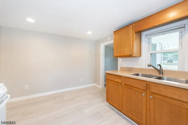 a kitchen with a sink cabinets and a window
