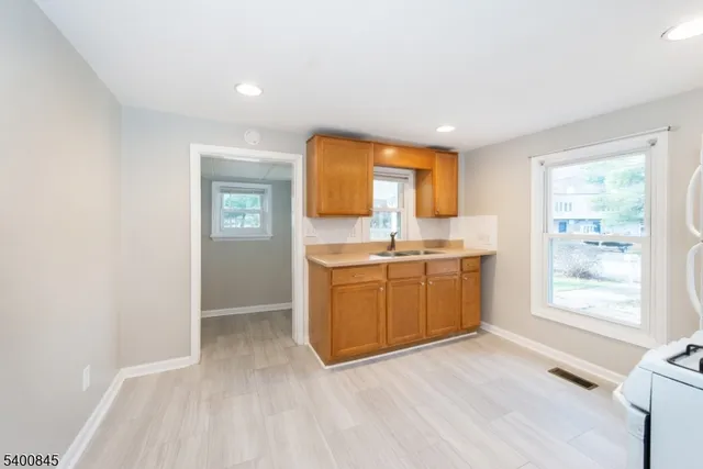 a view of a kitchen with a sink and a window