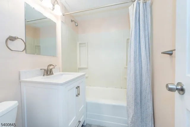 a bathroom with a sink mirror toilet and bathtub