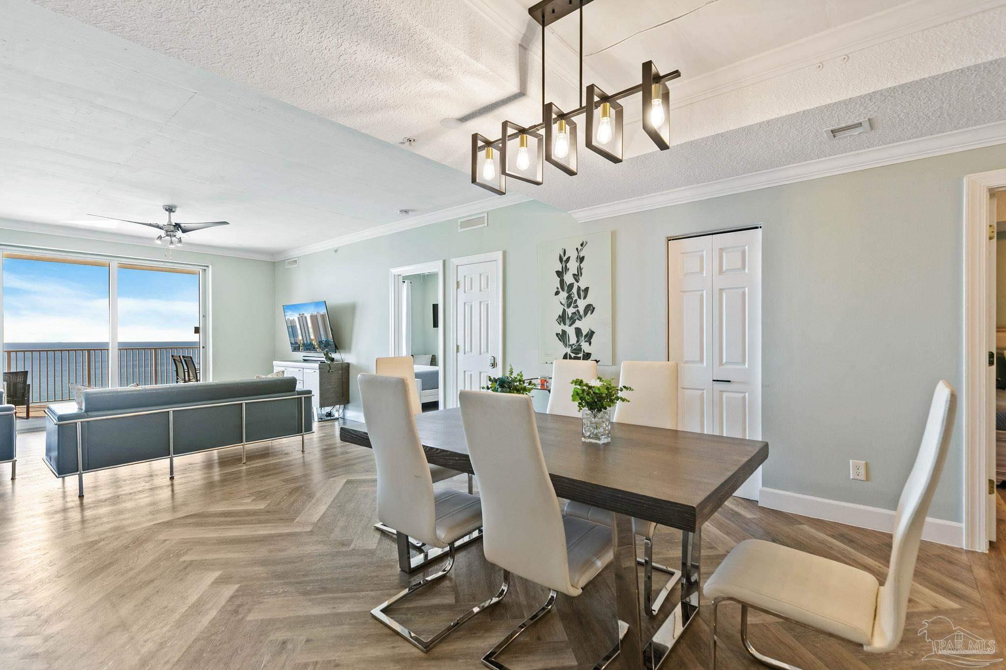 10611 Front Beach Road, Unit 1303 Panama City Beach, FL 32408 - Photo 19 of 71 a view of a dining room with furniture window and wooden floor