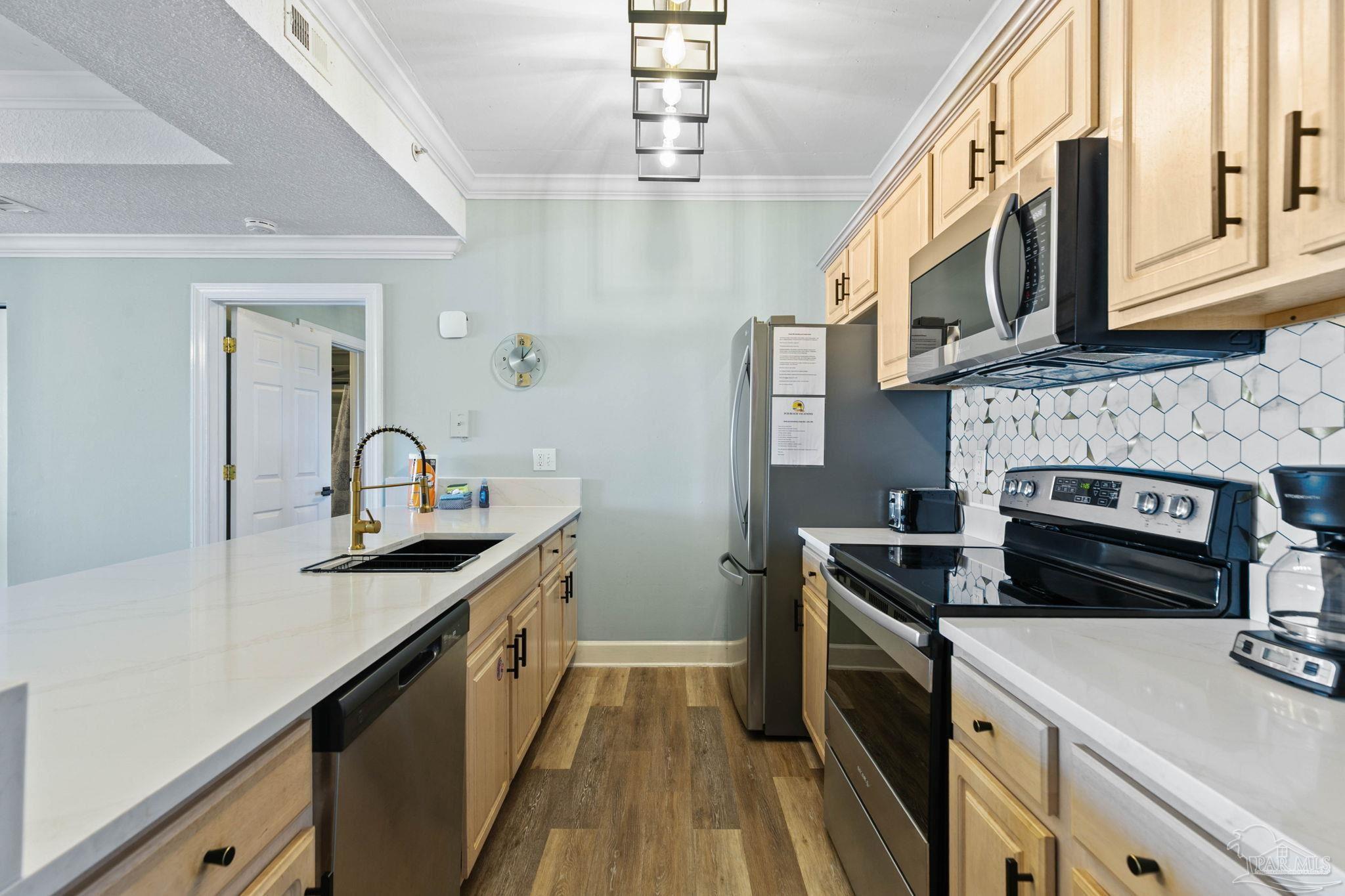 10611 Front Beach Road, Unit 1303 Panama City Beach, FL 32408 - Photo 23 of 71 a kitchen with a sink and stove