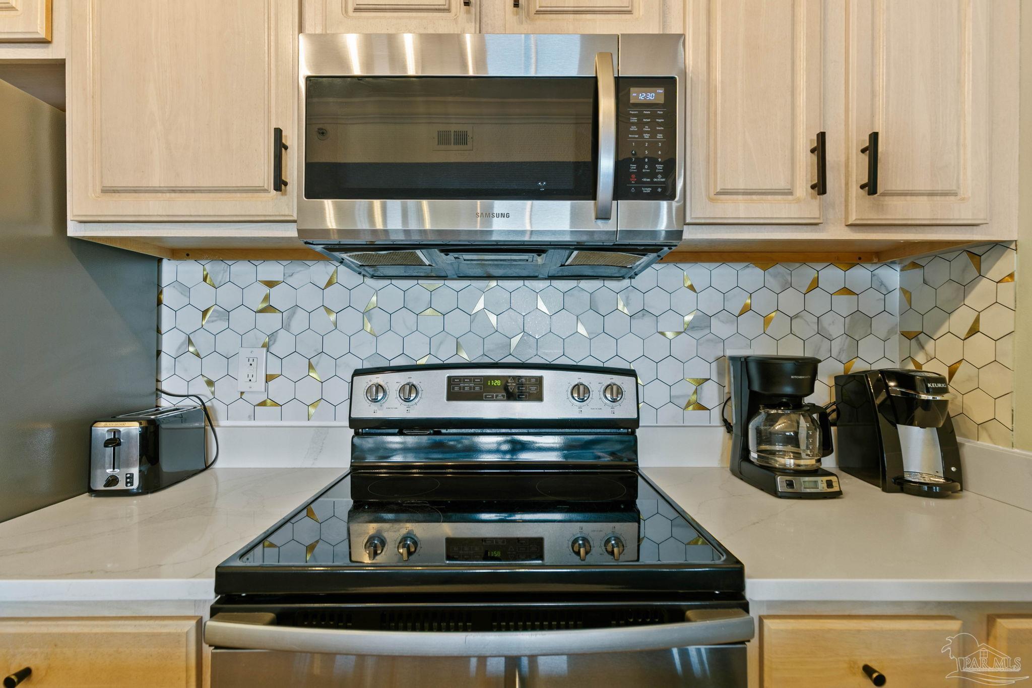 10611 Front Beach Road, Unit 1303 Panama City Beach, FL 32408 - Photo 27 of 71 a stove top oven sitting inside of a kitchen