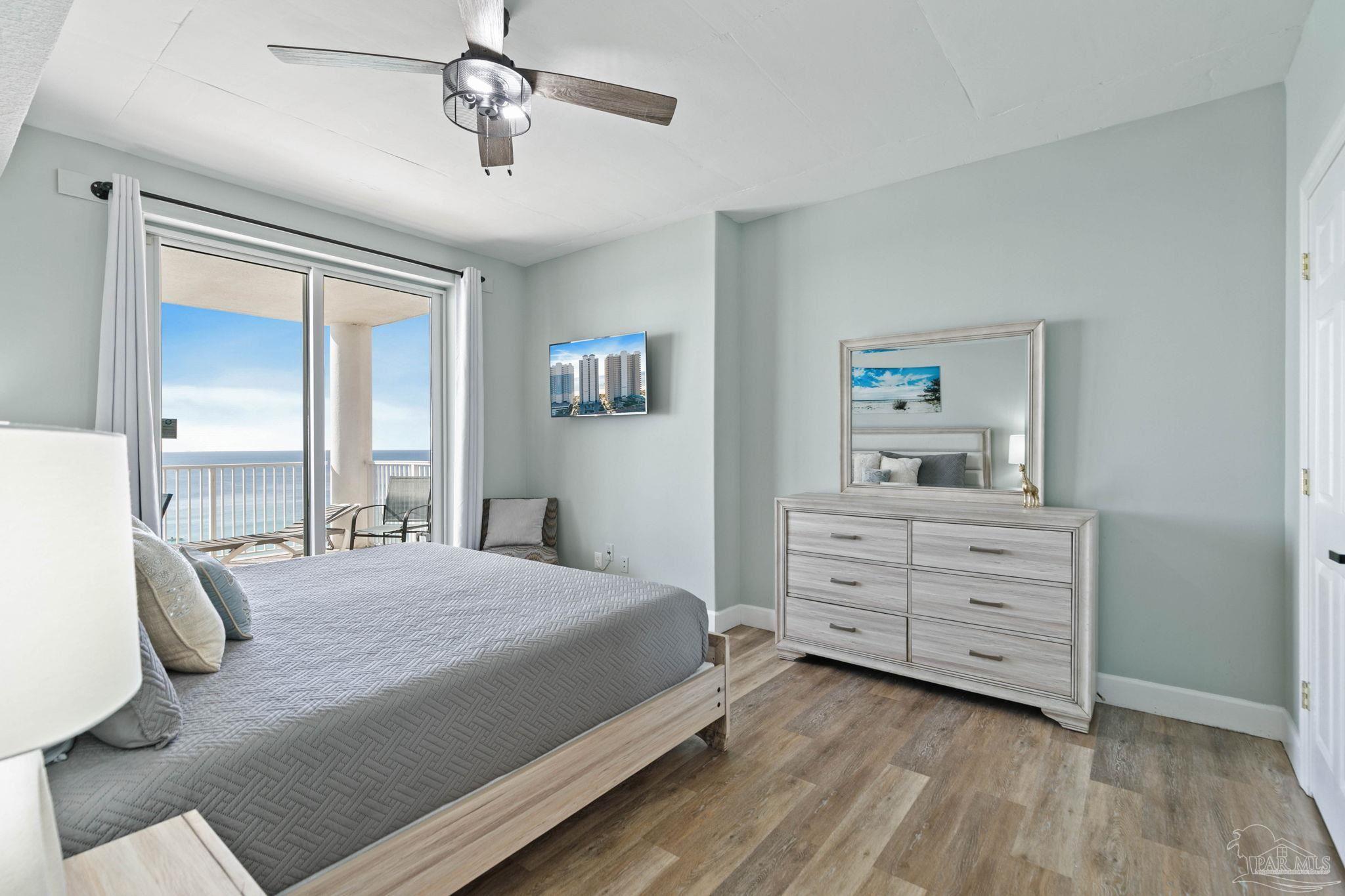 10611 Front Beach Road, Unit 1303 Panama City Beach, FL 32408 - Photo 34 of 71 a bedroom with a bed and a dresser