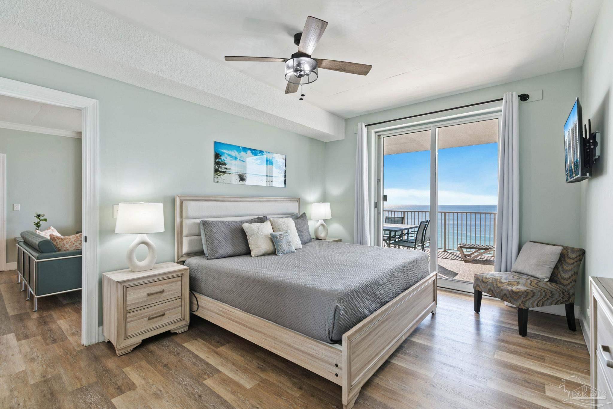 10611 Front Beach Road, Unit 1303 Panama City Beach, FL 32408 - Photo 35 of 71 a bedroom with a bed and a chandelier