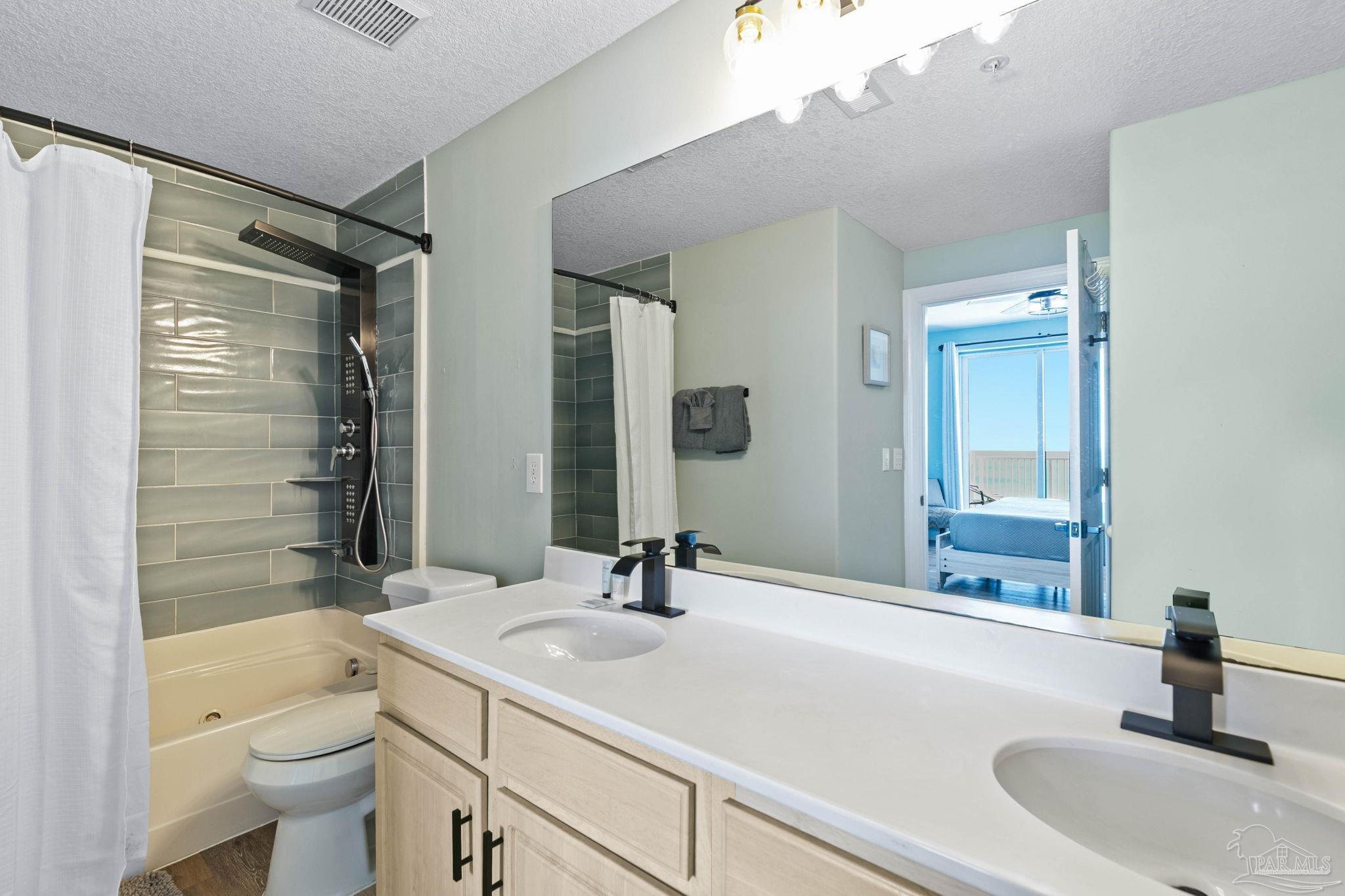 10611 Front Beach Road, Unit 1303 Panama City Beach, FL 32408 - Photo 38 of 71 a bathroom with a sink a toilet and shower