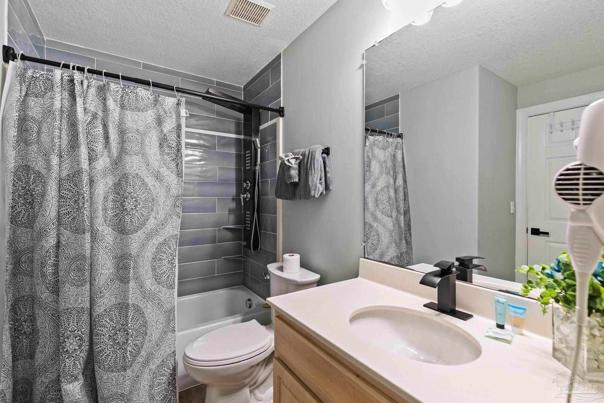 10611 Front Beach Road, Unit 1303 Panama City Beach, FL 32408 - Photo 42 of 71 a bathroom with a sink toilet and shower