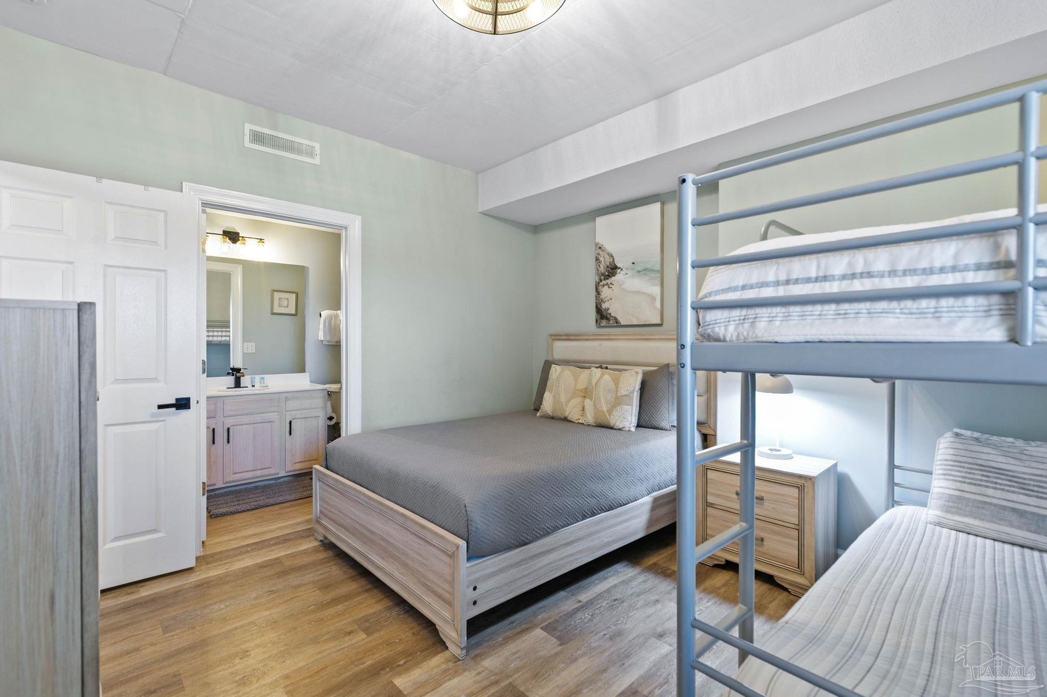 10611 Front Beach Road, Unit 1303 Panama City Beach, FL 32408 - Photo 44 of 71 a bedroom with a bed and a table