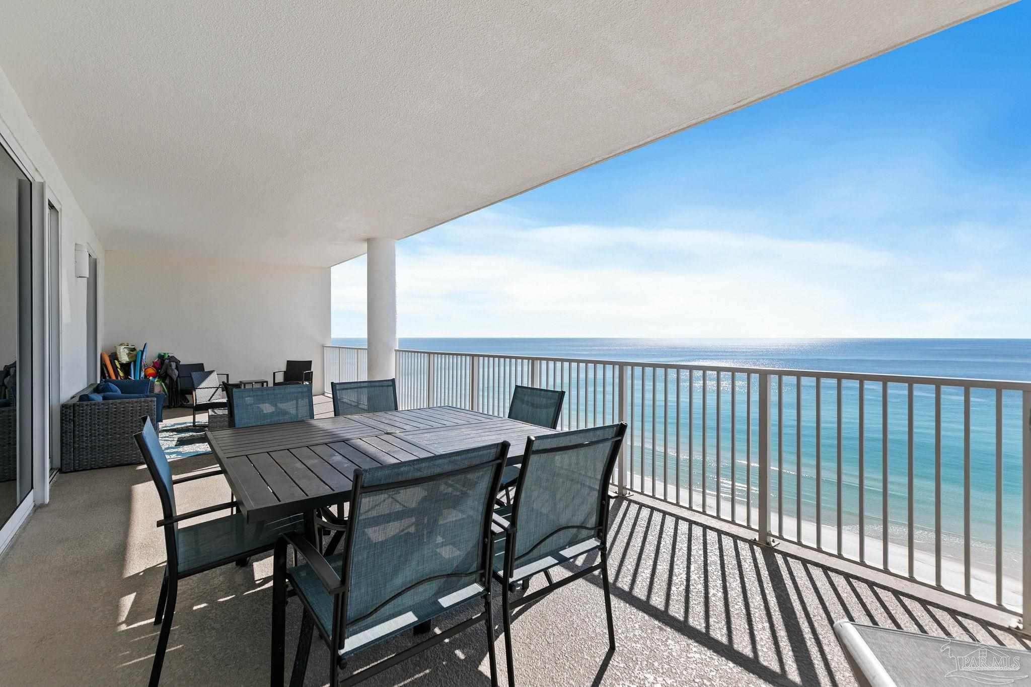 10611 Front Beach Road, Unit 1303 Panama City Beach, FL 32408 - Photo 47 of 71 a view of a dining room with furniture and wooden floor