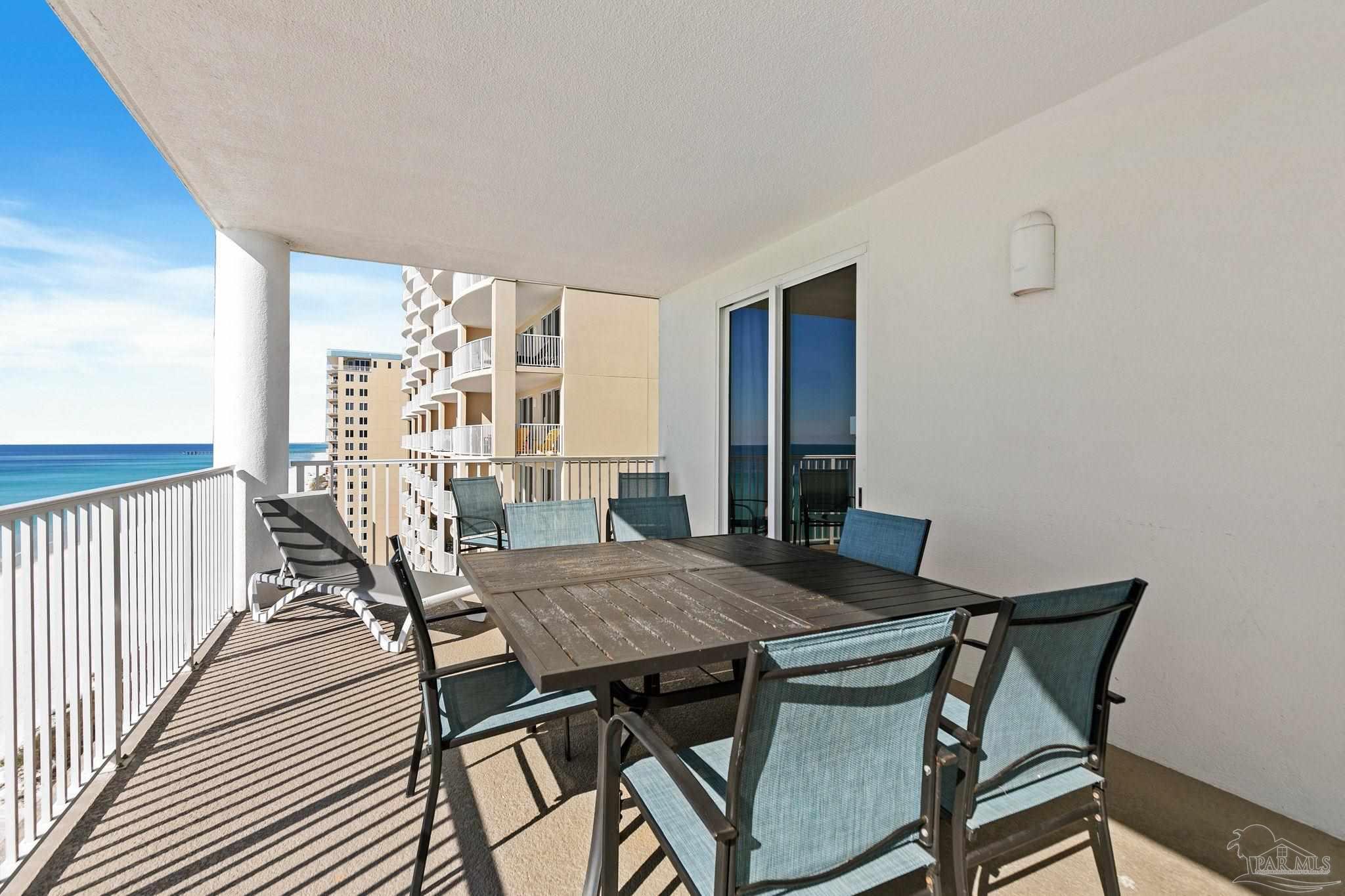 10611 Front Beach Road, Unit 1303 Panama City Beach, FL 32408 - Photo 48 of 71 a view of a dining room with furniture and wooden floor