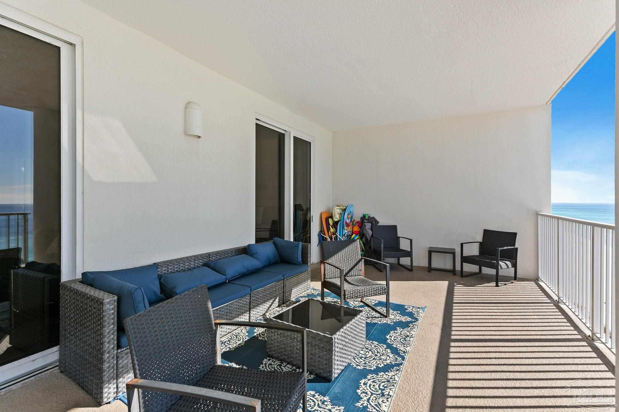 10611 Front Beach Road, Unit 1303 Panama City Beach, FL 32408 - Photo 49 of 71 a living room with furniture and wooden floor