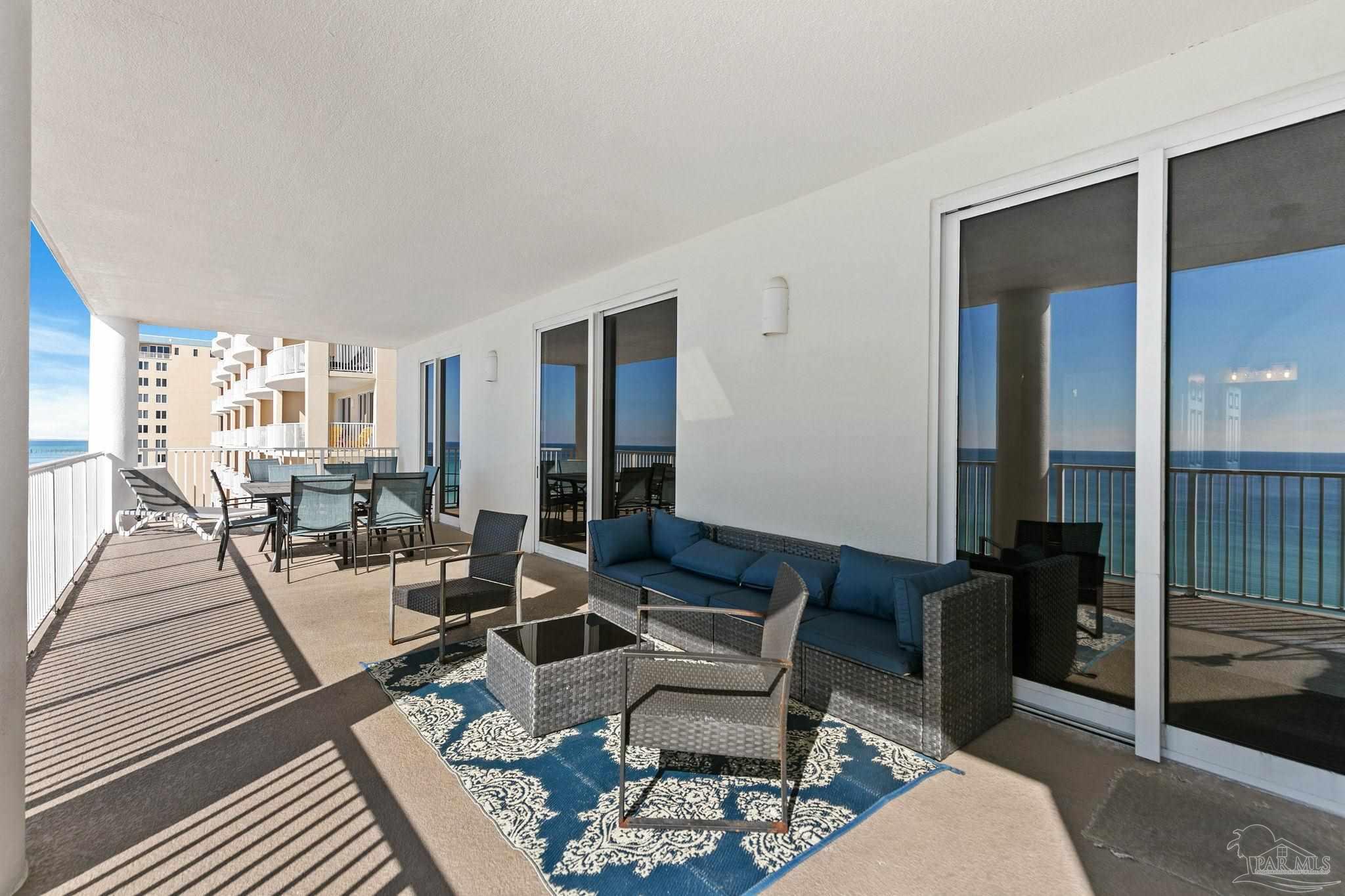 10611 Front Beach Road, Unit 1303 Panama City Beach, FL 32408 - Photo 50 of 71 a living room with furniture and a table